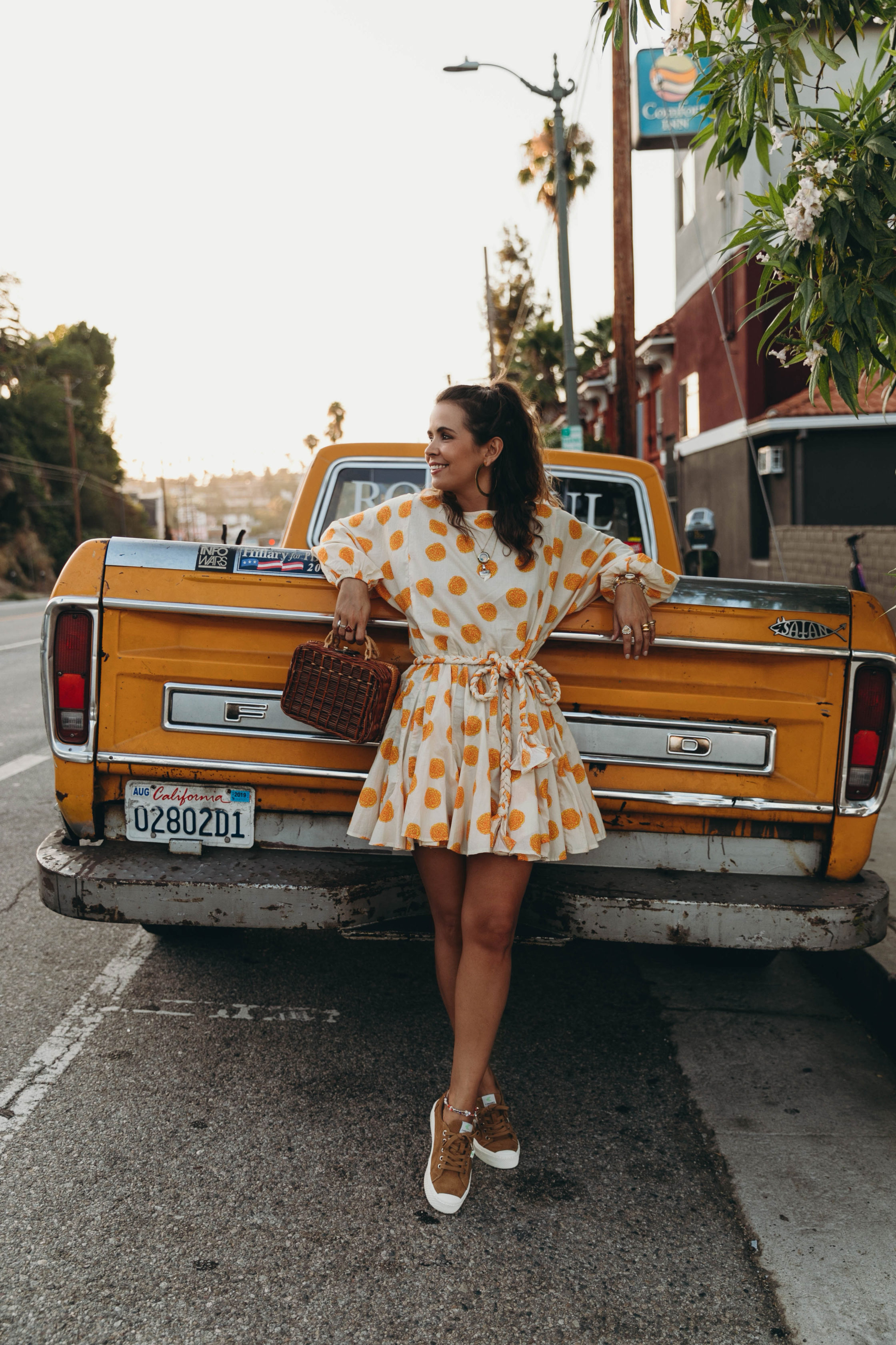 Sara Escudero of Collage Vintage wearing a Rhode dress and Cariuma suede sneakers