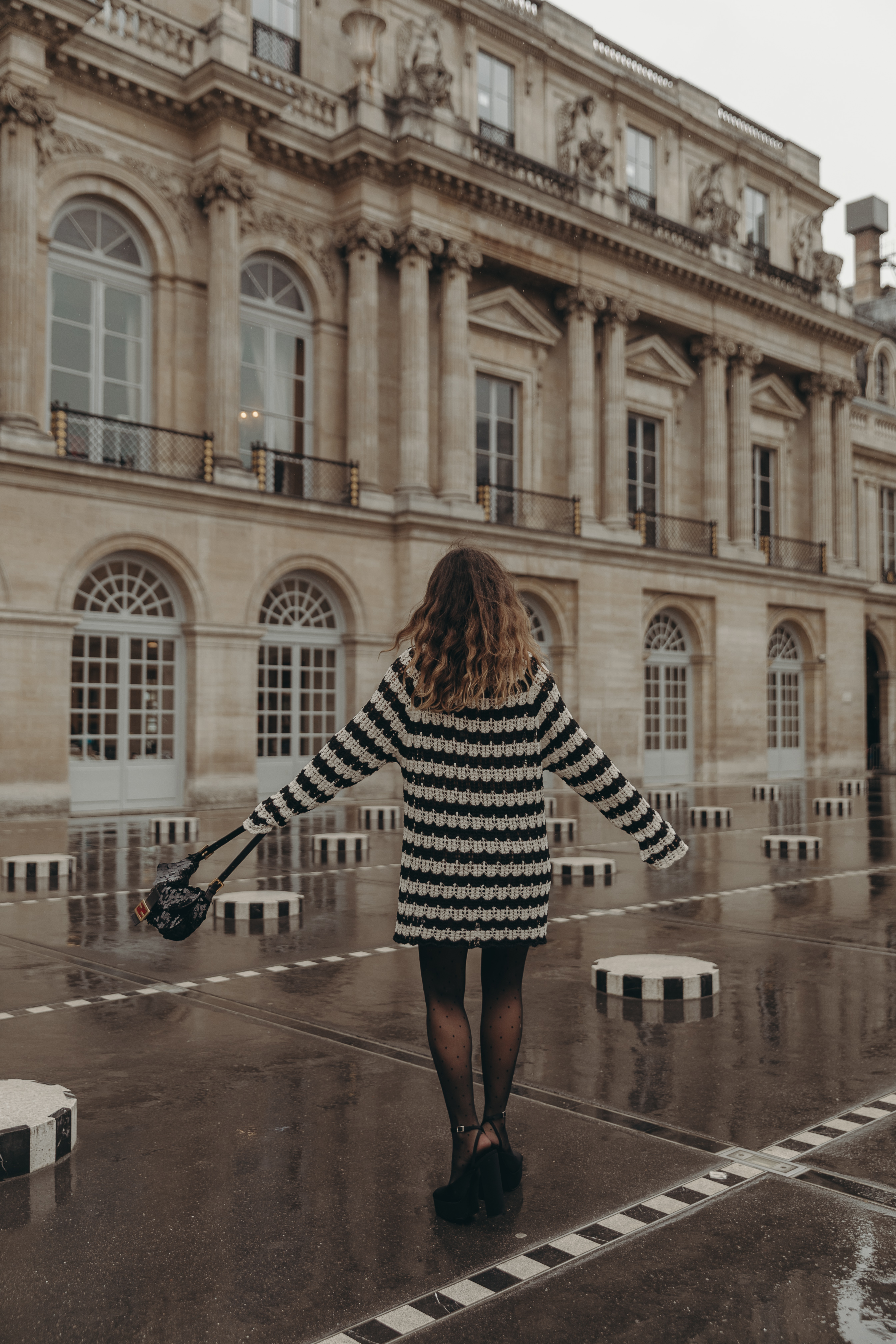 Sara from Collage Vintage at Paris Fashion Week. Wearing a striped knit long sweater, Fendi vintage bag and platform sandals.