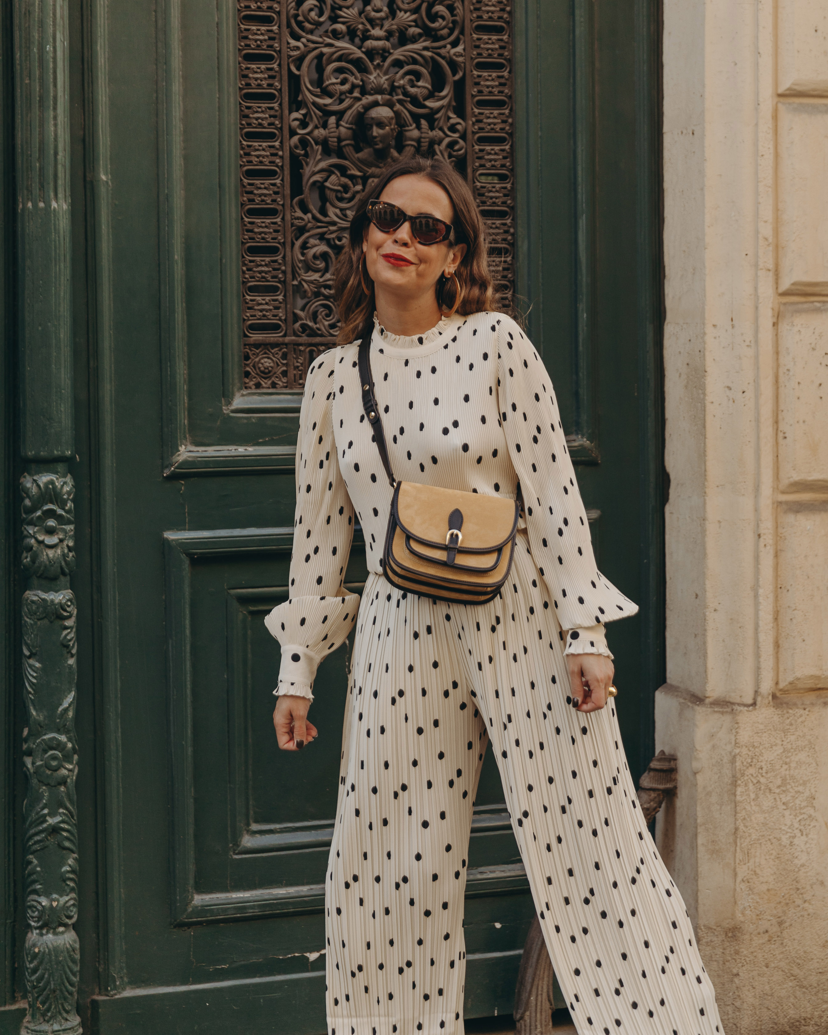 Sara from Collage Vintage at Saint Germain Paris wearing a Sézane polka dots set and a leather crossbody bag.